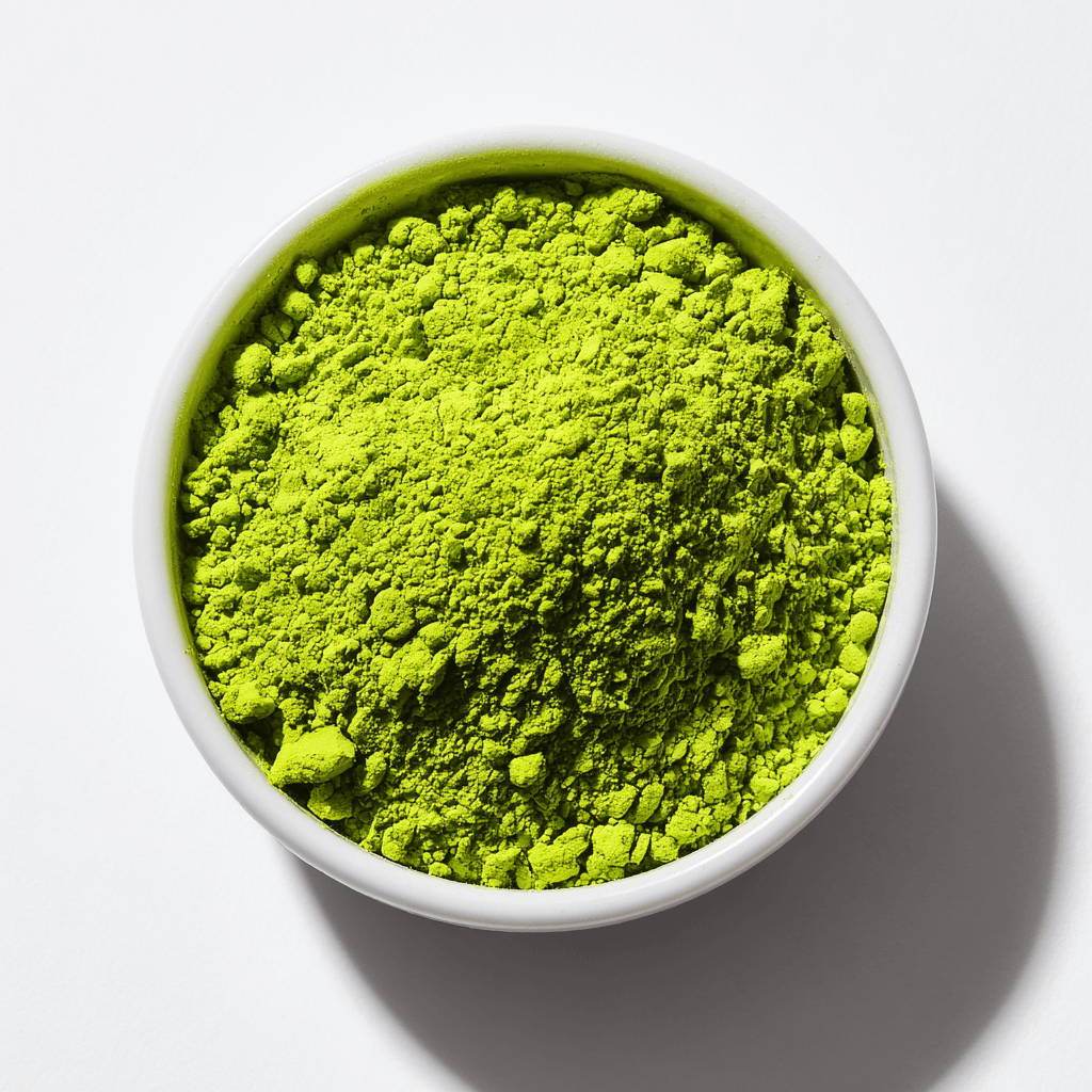 Matcha Ice Cream Recipe – Creamy, Refreshing, and Delicious 4 vibrant green matcha powder in a white ceramic dish on a white background