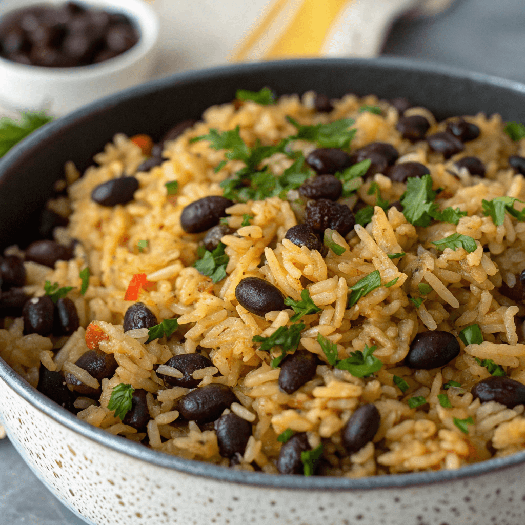 Finished black beans and rice shown in a clean top-view bowl.